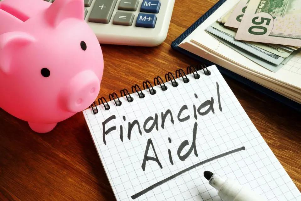 Financial aid notebook with calculator and savings