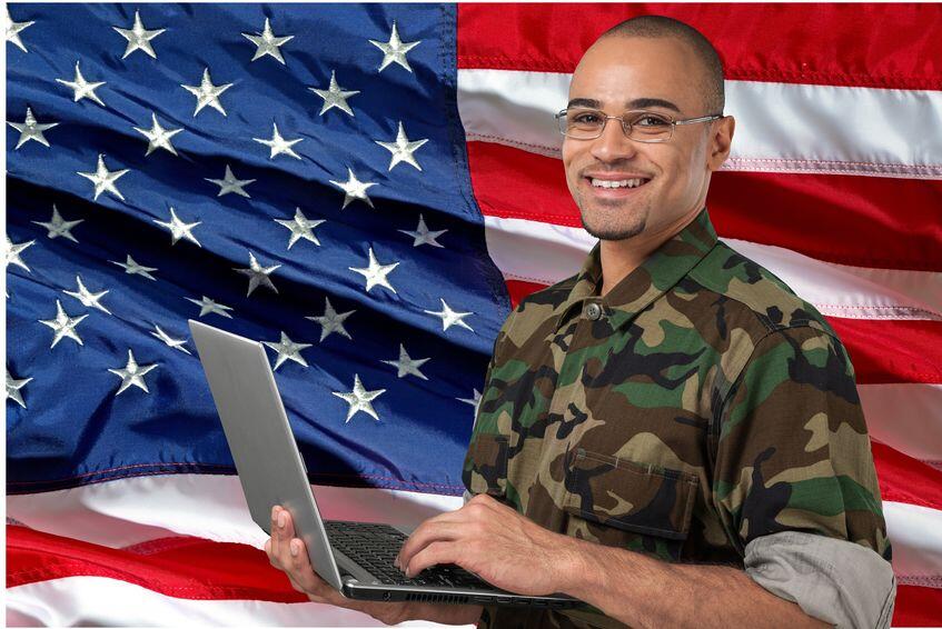 Veteran in uniform using a laptop for IT training