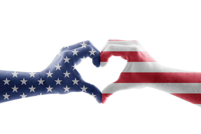 Hands forming a heart shape in the colors of the American flag
